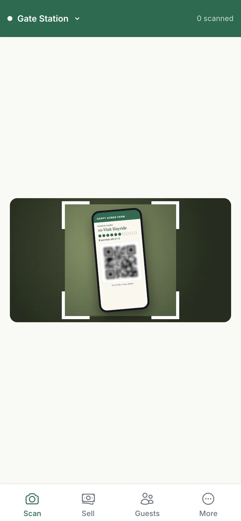 The SiloPass scanner on a staff phone at the Gate Station, with a guest's digital punch card in the camera frame